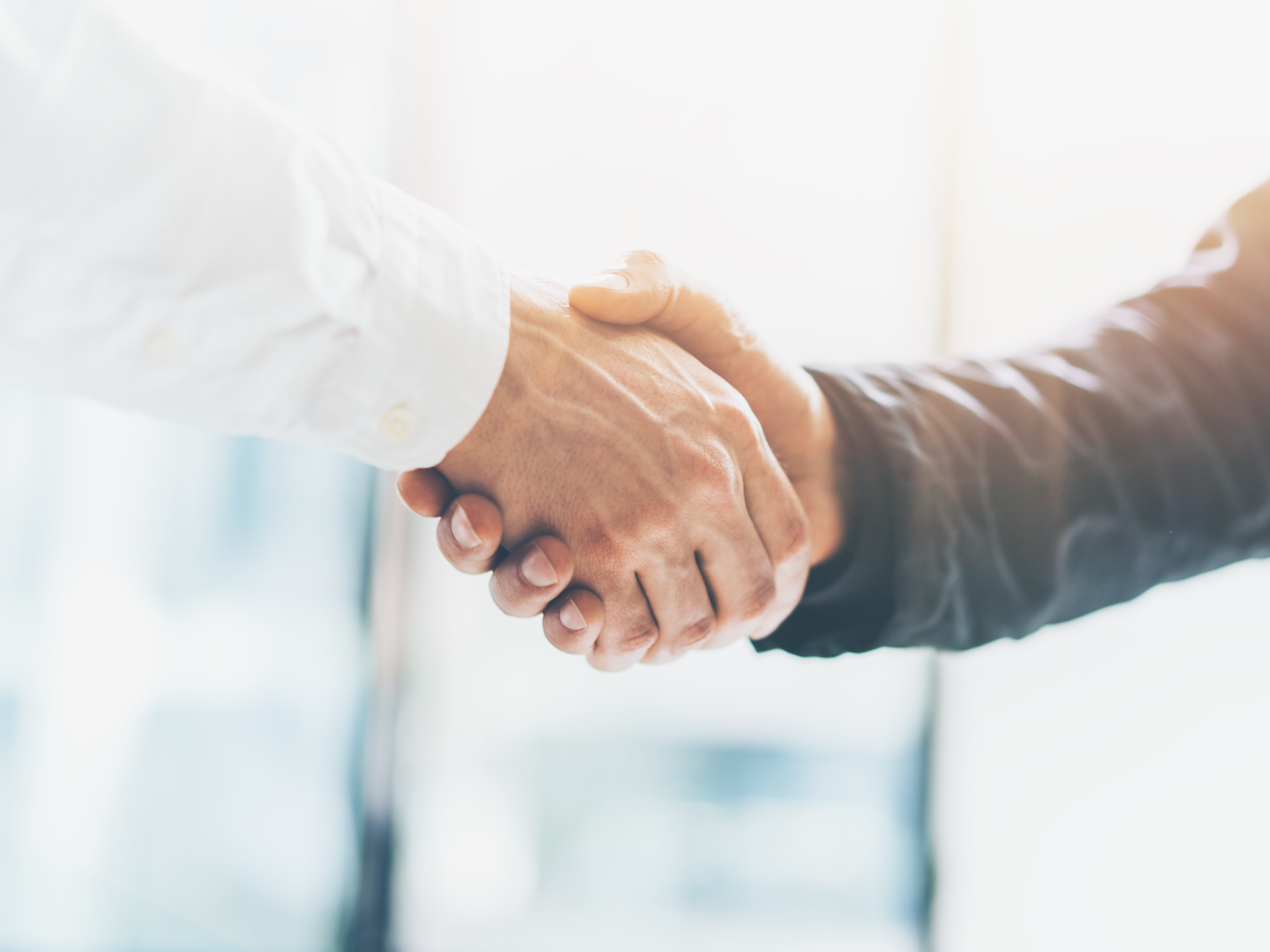 Business partnership meeting. Picture businessmans handshake. Successful businessmen handshaking after good deal. Horizontal, blurred background